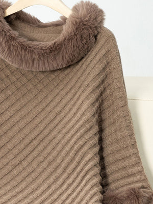 Camel knit poncho with faux fur trim at neckline and cuffs.
