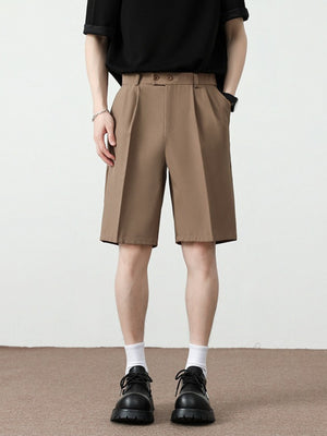 Men's light brown pleated detail loose-fit chino shorts with a relaxed cut.