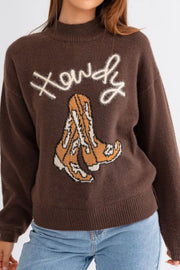 Brown mock neck sweater with "Howdy" and cowboy boot graphic.