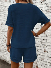 Dark blue textured knit set with fringe detail on short sleeves and shorts.