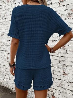 Dark blue textured knit set with fringe detail on short sleeves and shorts.