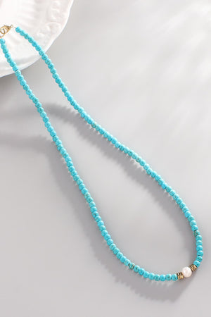 Turquoise bead necklace with pearl and gold accents