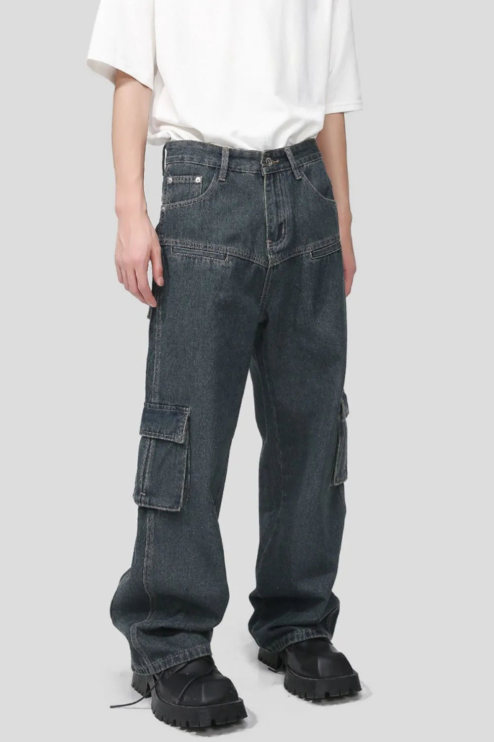 Panelled dark wash denim cargo pants with multiple pockets and a relaxed fit.