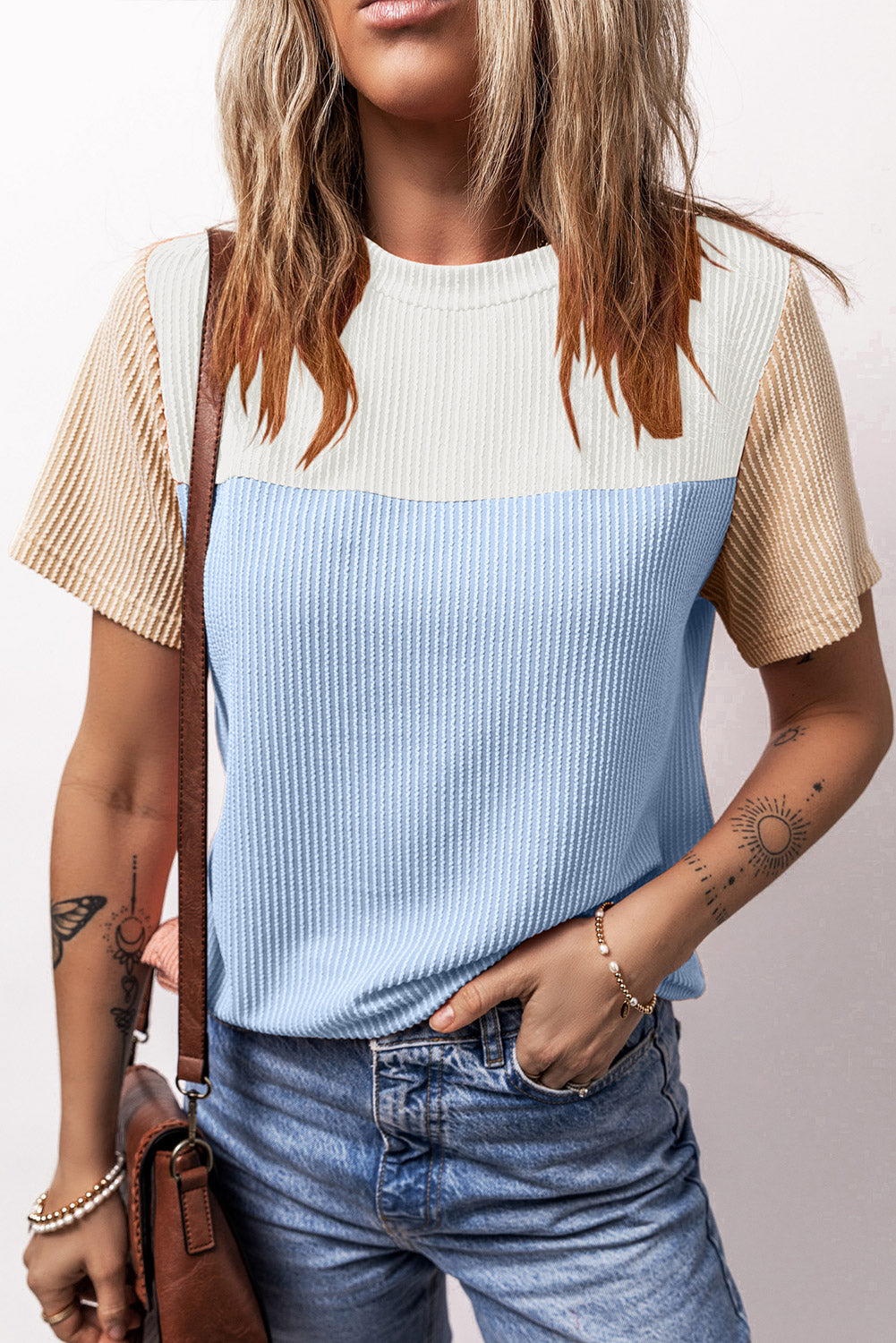 Panelled ribbed tee with textured sleeves in white, light blue, and tan.