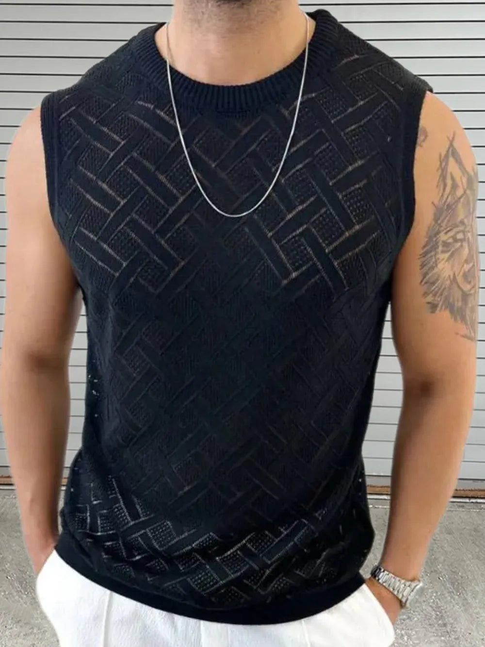 Black geometric knit sleeveless sweater with a crew neck.