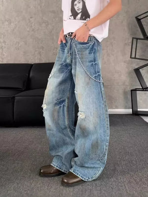 Distressed wide-leg denim jeans for men with chain detail and ripped accents.