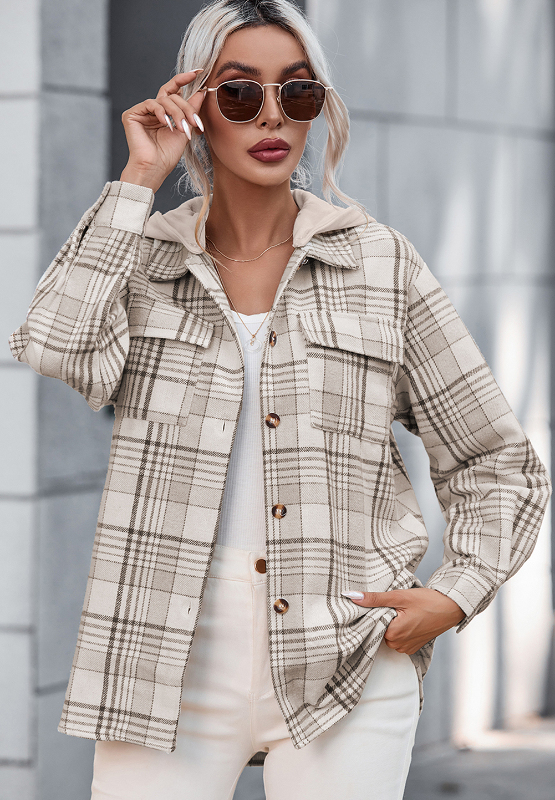 Oversized plaid shacket with attached hoodie, featuring button front and chest pockets.