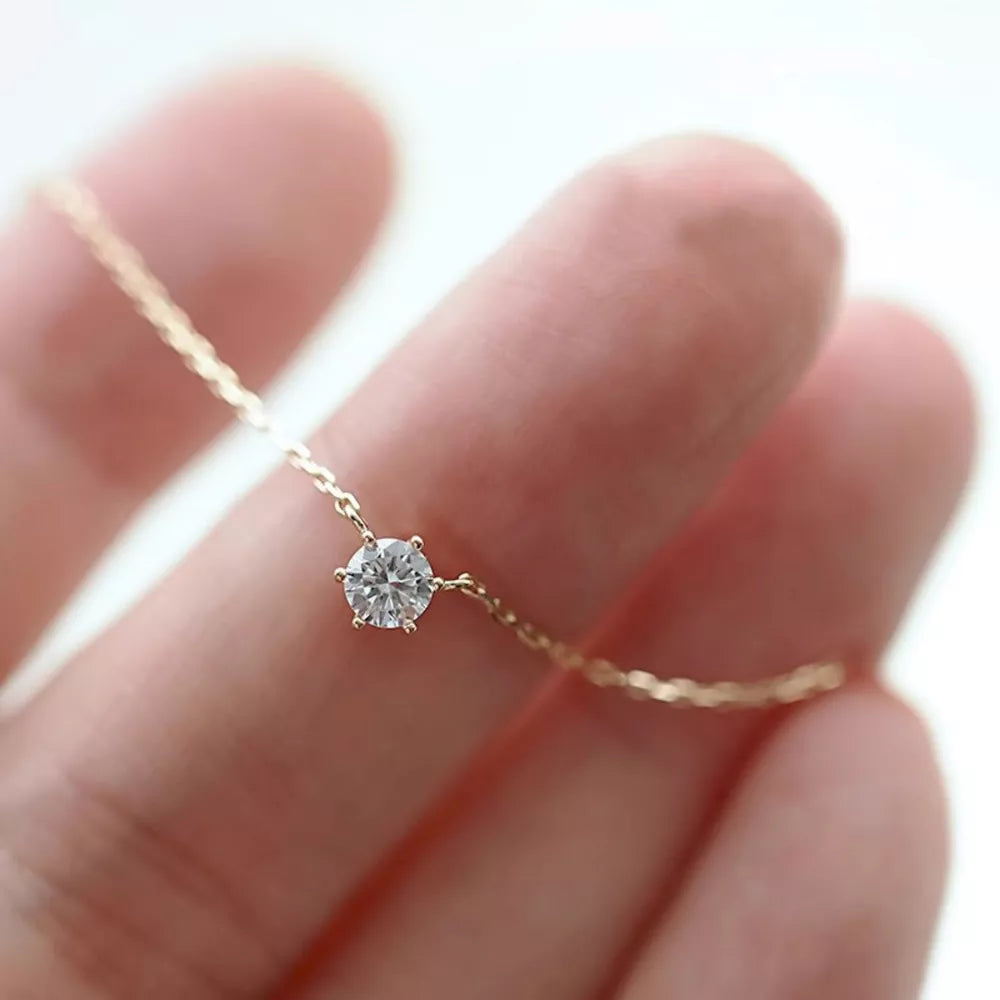 Delicate sterling silver necklace with a single clear zircon pendant.