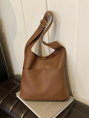 Brown textured pu leather shoulder bag with adjustable strap and front pockets