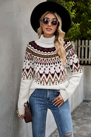 Geometric knit turtleneck sweater in cream with burgundy, brown, and black pattern.