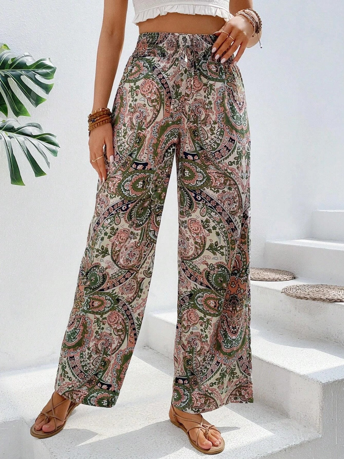 Paisley palazzo trousers with drawstring waist in multicolor, featuring a wide leg and boho print.
