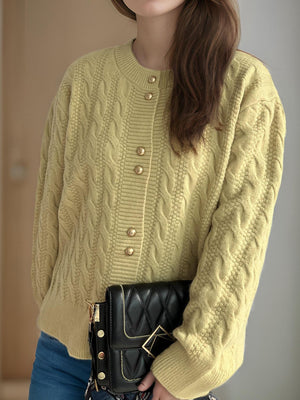Pastel Yellow cable knit cardigan with puff sleeves and gold buttons.