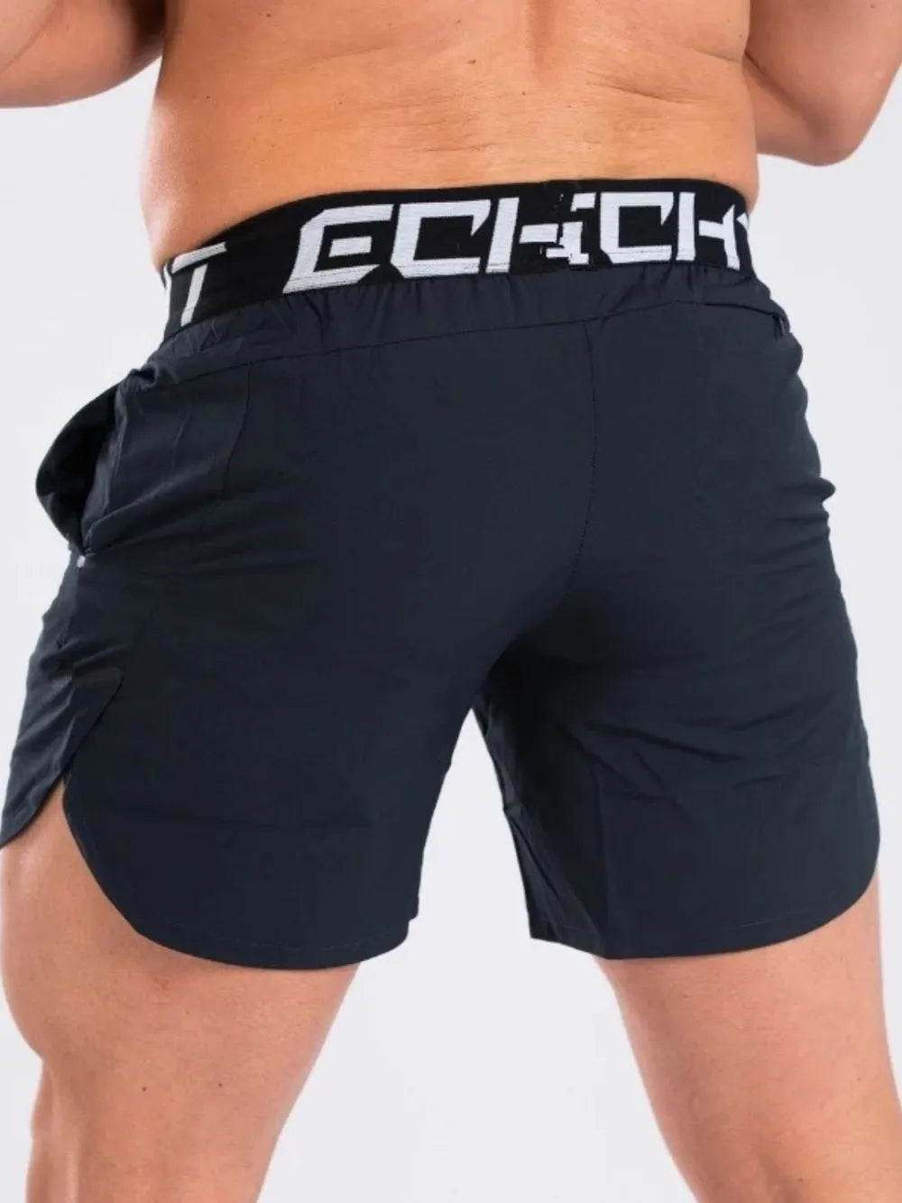 Black performance training shorts with branded waistband and side slits