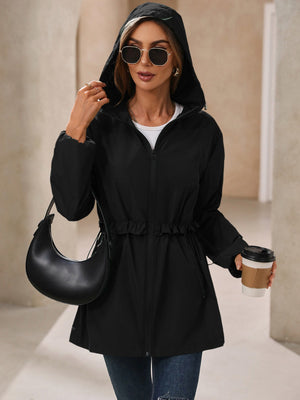 Black hooded performance jacket with ruffled drawstring waist and zip front.