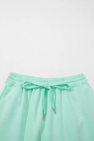 Mint green drawstring lounge shorts with elastic waistband and pockets.