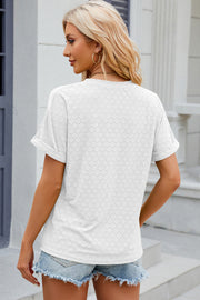 White textured henley tee with rolled sleeves and a perforated pattern.