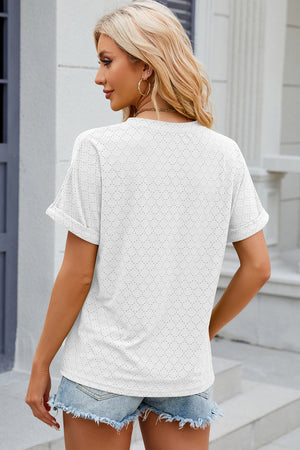 White textured henley tee with rolled sleeves and a perforated pattern.