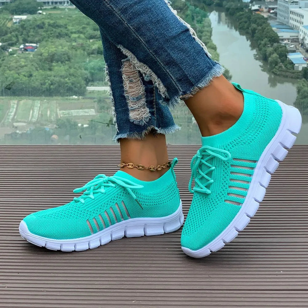 Aqua knit runner sneakers with white soles and stripe detail.
