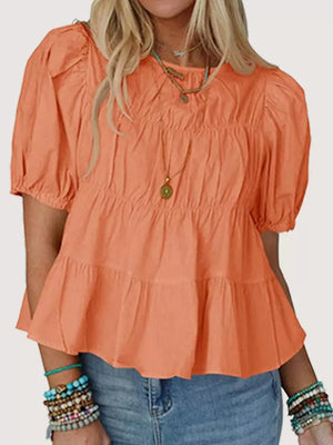 Orange maternity blouse with puff sleeves, ruffled tiers, and smocked bodice.
