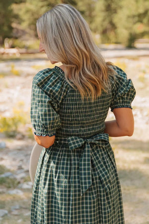Plaid maxi dress with smocked bodice, puff sleeves, and tie waist.