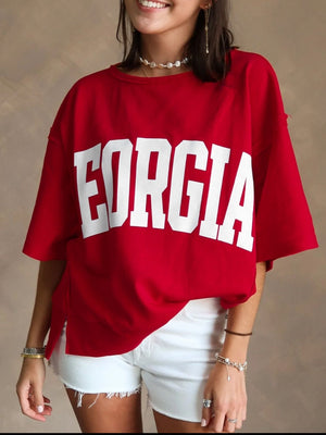 Red cotton blend t-shirt with white bold "GEORGIA" lettering, drop shoulders, and side slits.