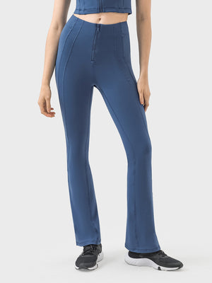 Dark blue activewear pants with a zip front and flared leg