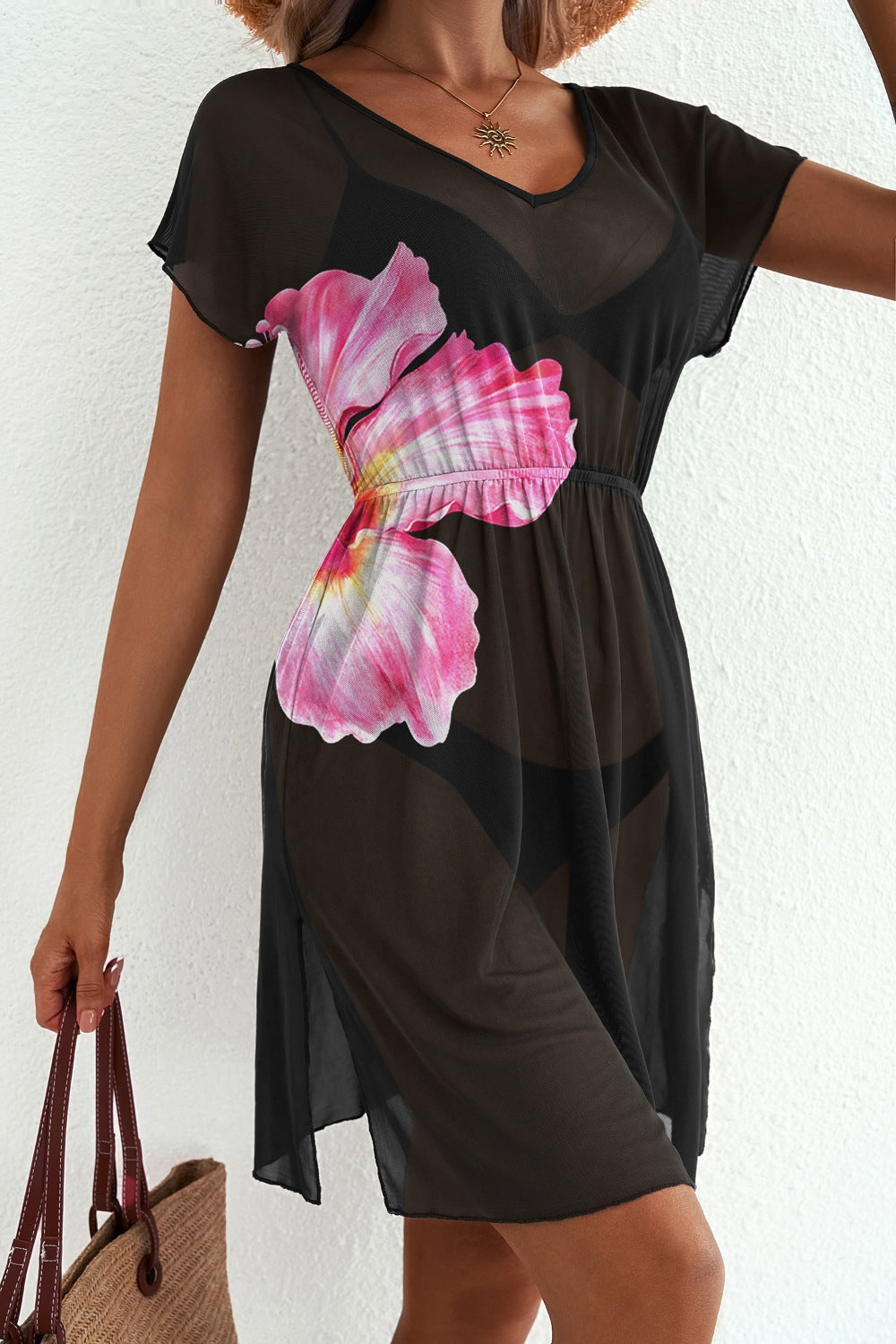 Black sheer V-neck beach cover-up with pink floral print and short sleeves.