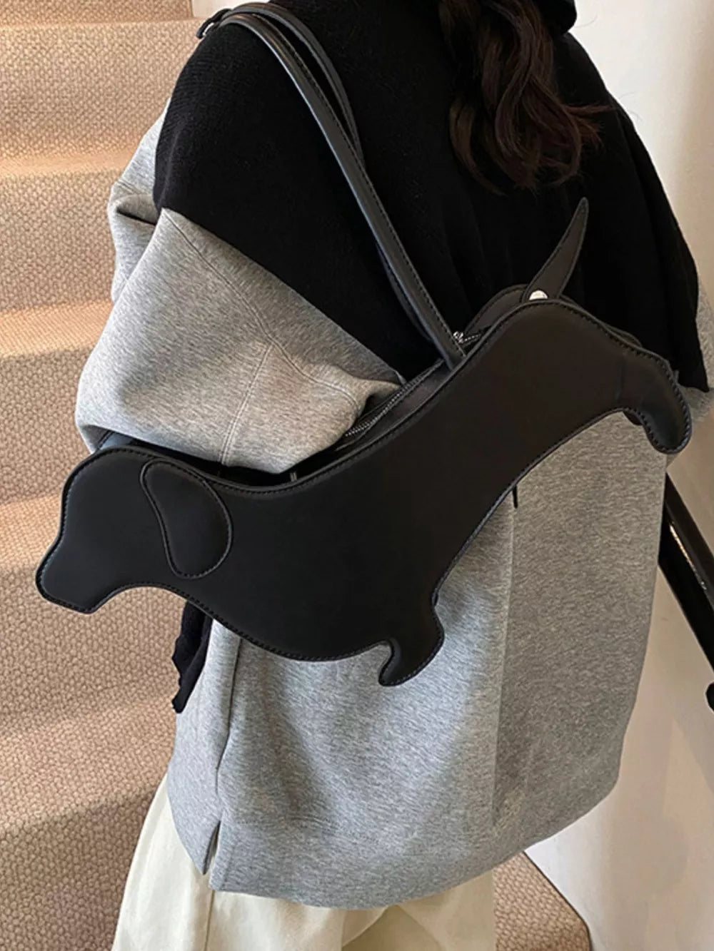 Black PU leather dachshund shoulder bag with charming dog shape detail.