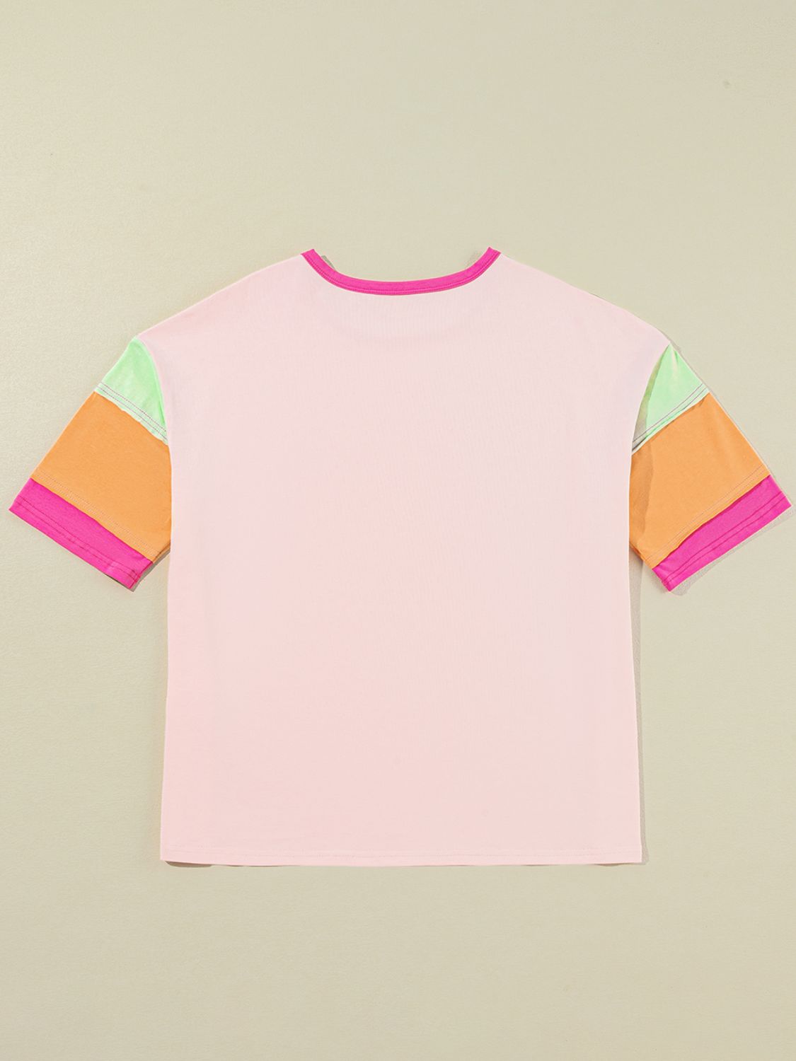 Colorblock tee in watermelon pink with colorblocked sleeves in orange, light green, and pink.