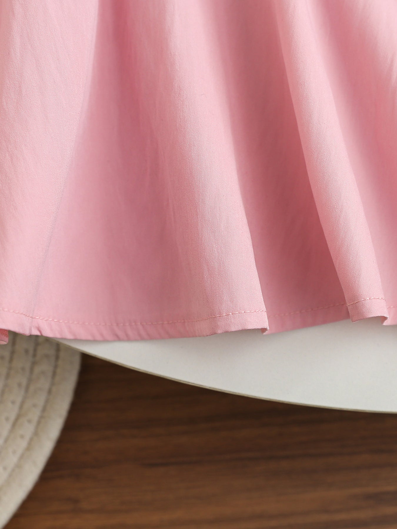 Pink cotton blend baseball dress for kids, showing gathered skirt detail.