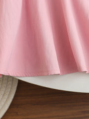 Pink cotton blend baseball dress for kids, showing gathered skirt detail.