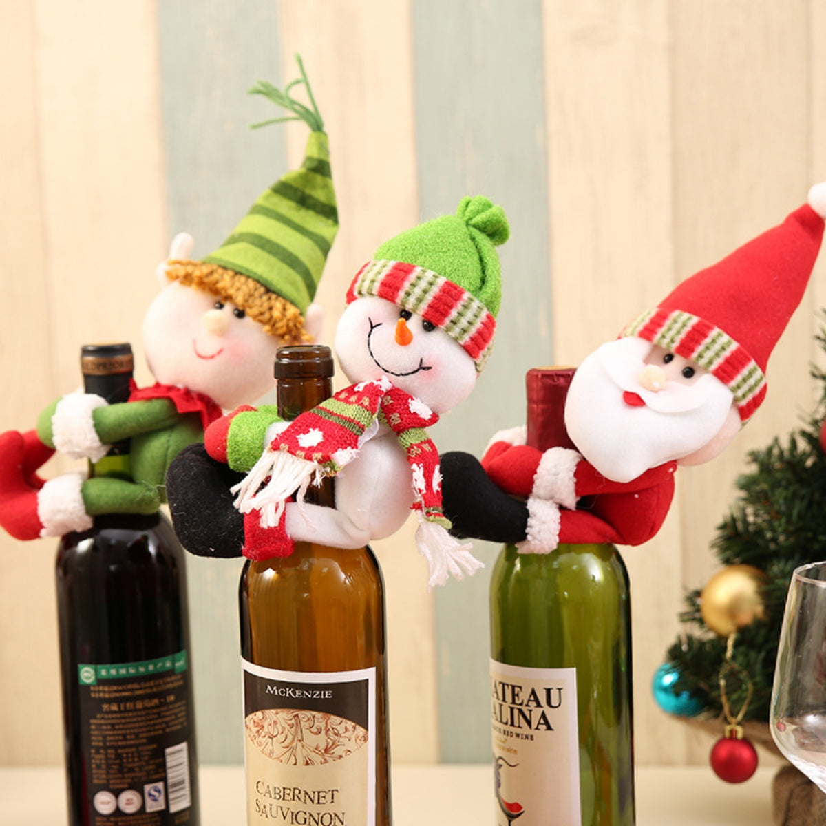 Festive bottle huggers with Christmas characters: elf, snowman, and Santa.