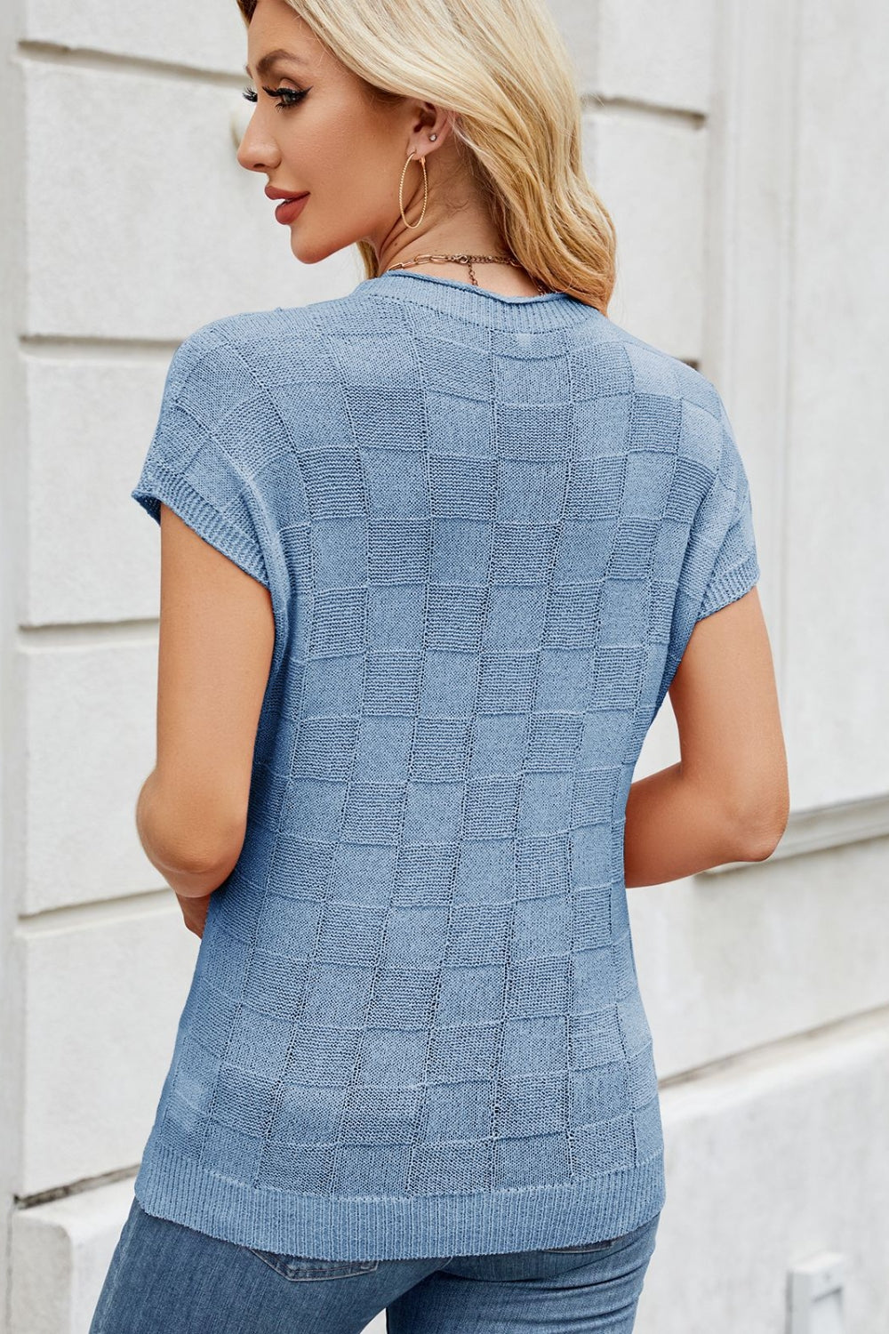 Sky blue knit top with short sleeves and a checkered texture.