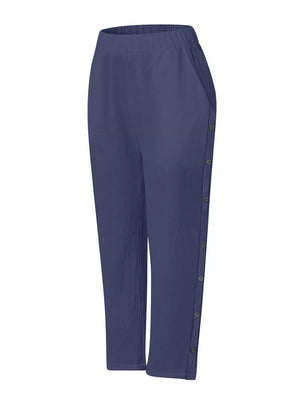 Navy blue relaxed fit pants with decorative side buttons and pockets.