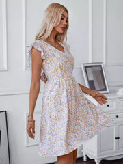 Ditsy floral mini dress with ruffled sleeves and V-neckline.