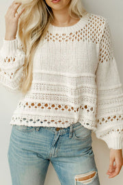 Ivory openwork knit pullover sweater with balloon sleeves and a crew neck.