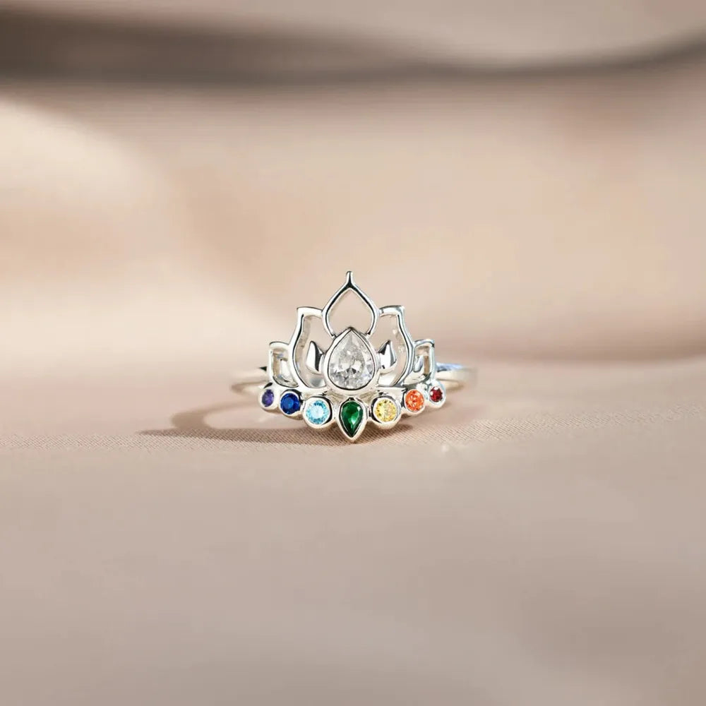 Sterling silver ring with lotus design and colorful chakra gemstones.