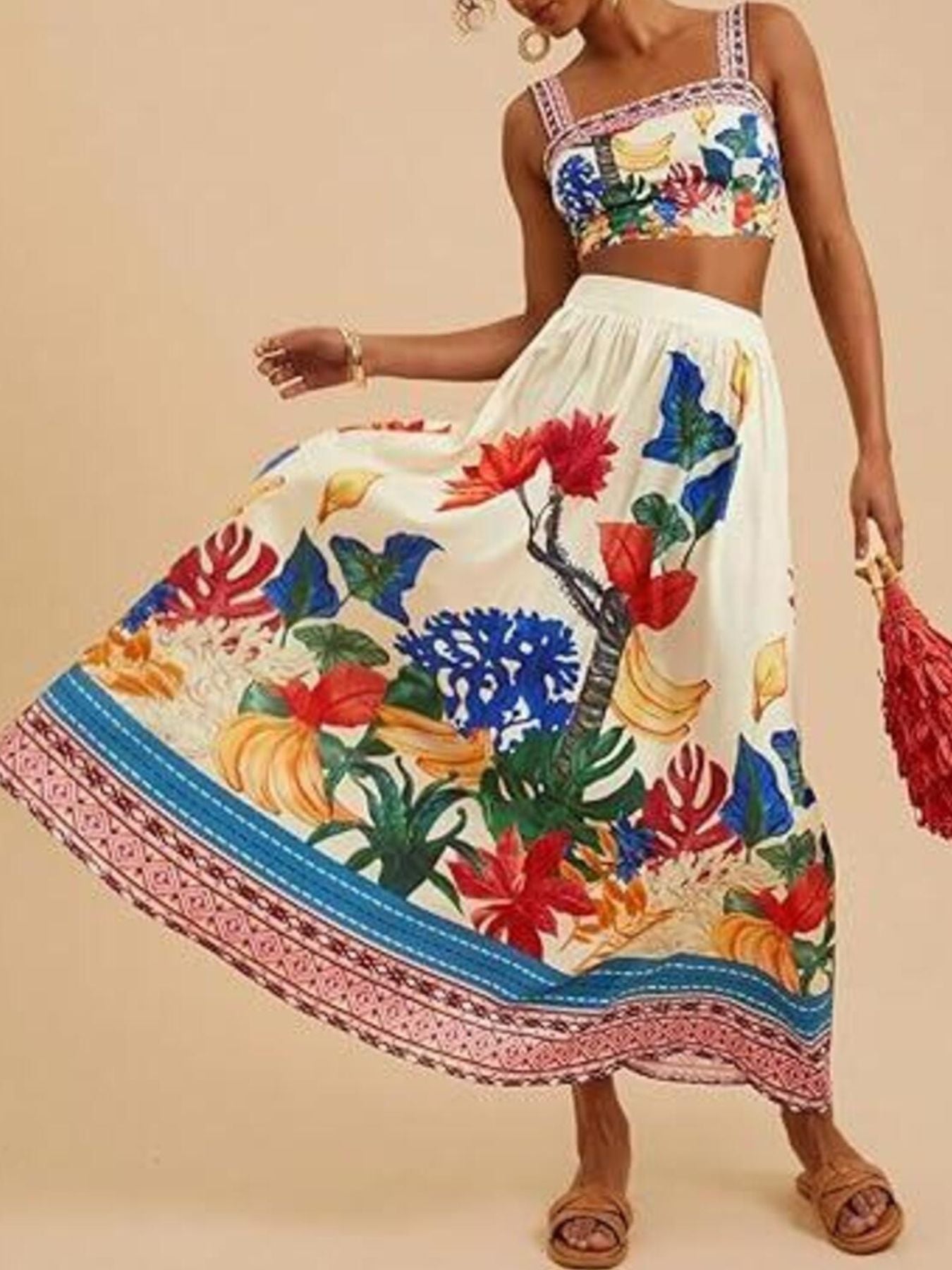 Floral print crop top and maxi skirt set with tropical motifs.