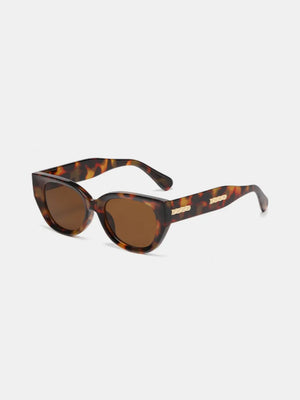 Sculpted cat eye sunglasses in tortoiseshell with brown lenses and gold detail.