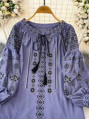 Purple embroidered tie neck blouse with tassels and peasant sleeves.