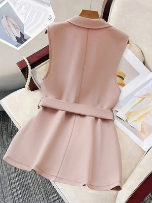Sleeveless blush blazer vest with a matching waist-defining belt and peplum hem.
