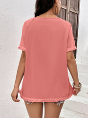 Coral raglan sleeve tee with fringed hem and sleeves.