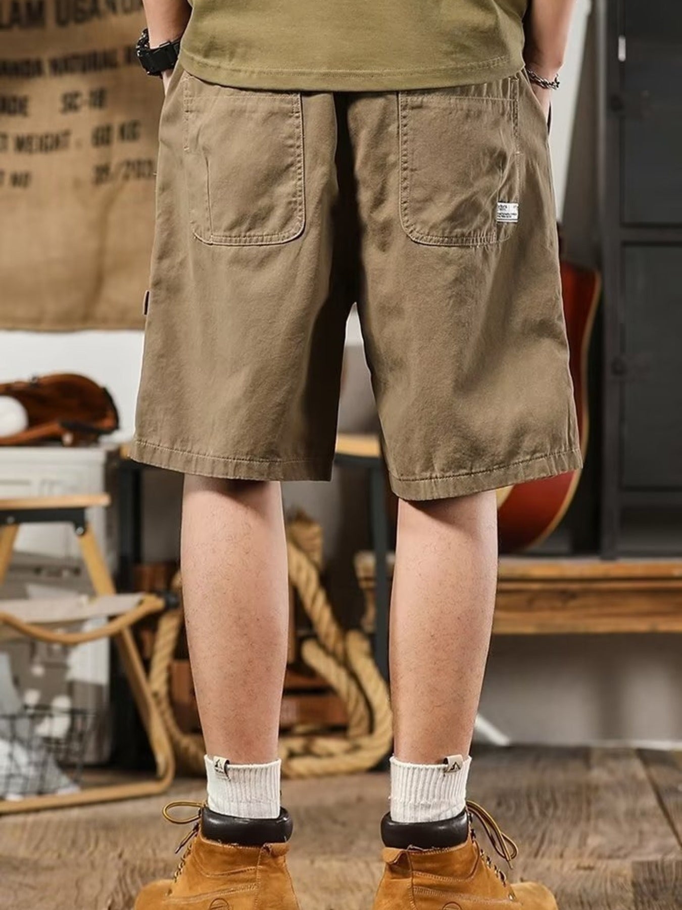 Men's taupe relaxed fit drawstring shorts with two back pockets and a small tag detail.