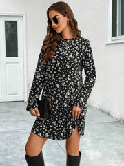 Black floral swing mini dress with long sleeves and side slit, styled with a clutch.