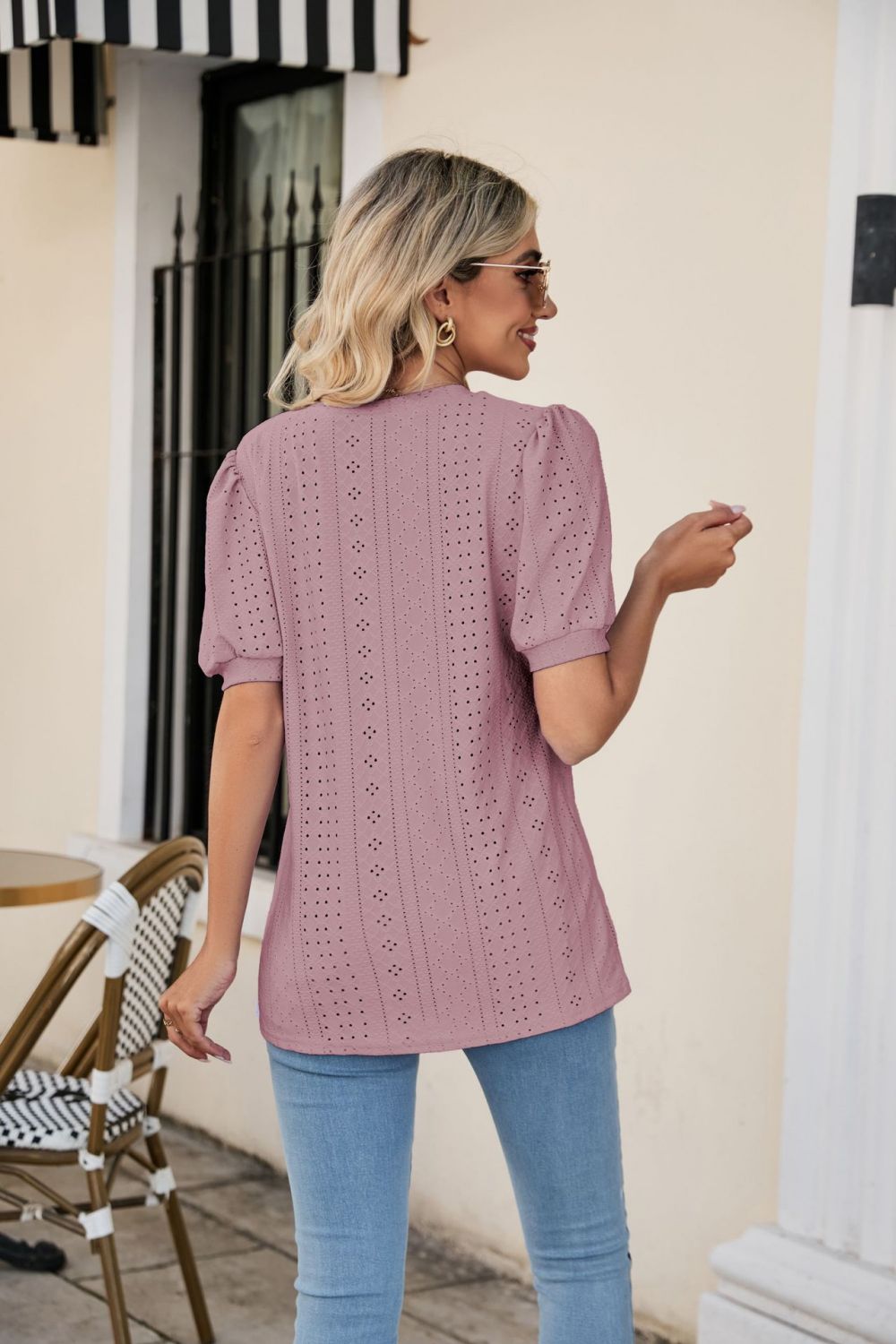 Perforated puff sleeve V-neck top in blush pink with eyelet detail.
