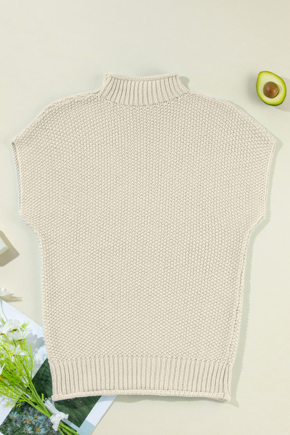 Boxy knit turtleneck shell sweater in beige with short sleeves and ribbed hem.