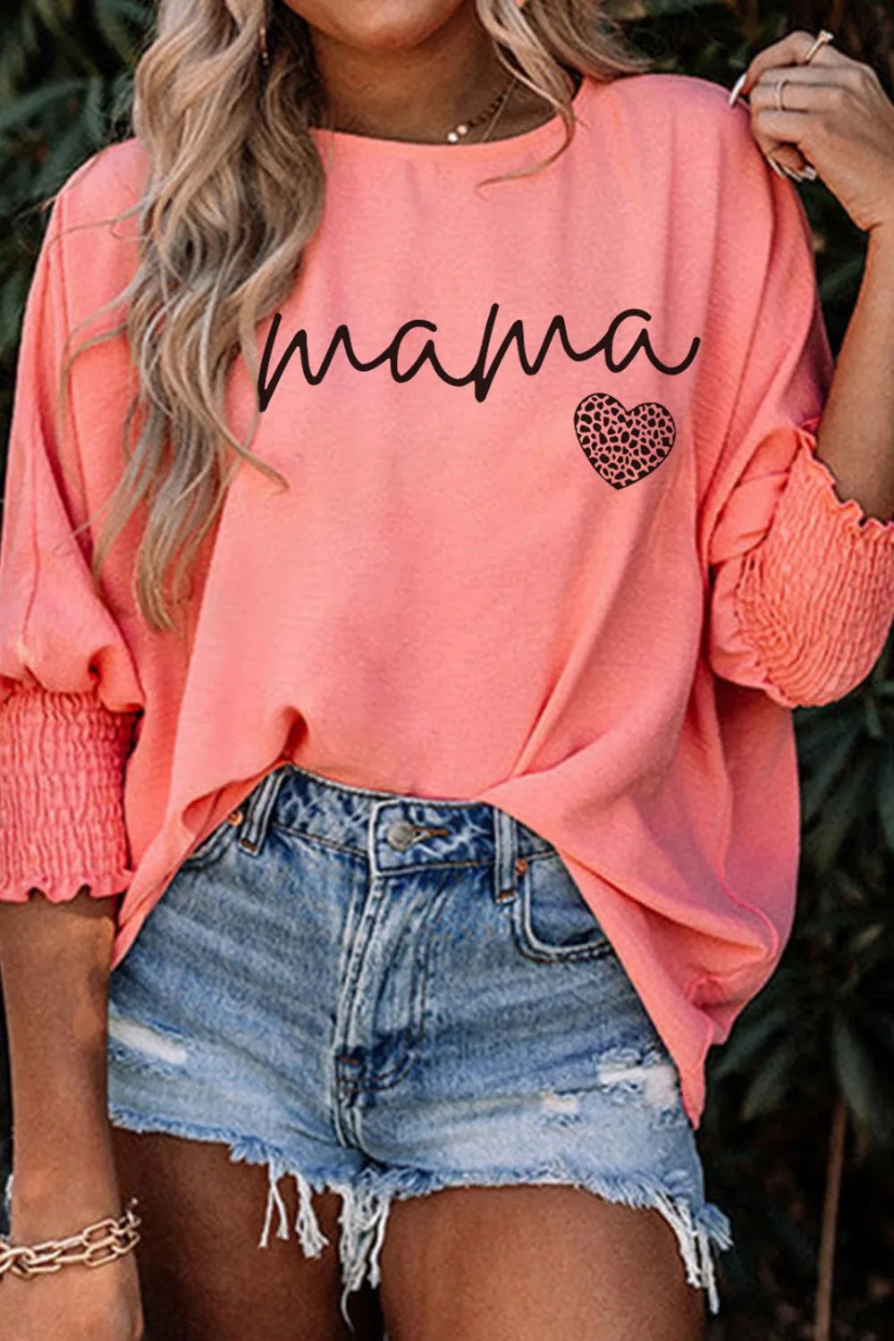 Coral mama heart print blouse with blouson sleeves and smocked cuffs.