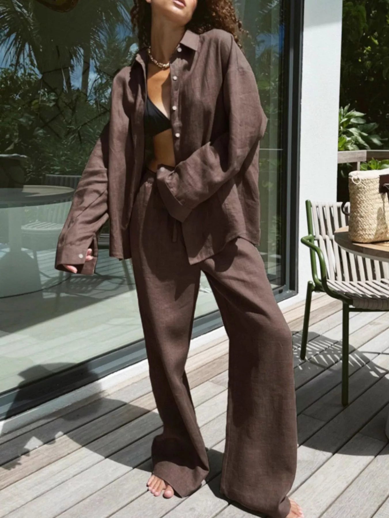 Brown relaxed fit linen two-piece set with button-up shirt and wide-leg pants.