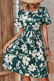 Forest green floral midi dress with flutter sleeves, pleated skirt, and belt