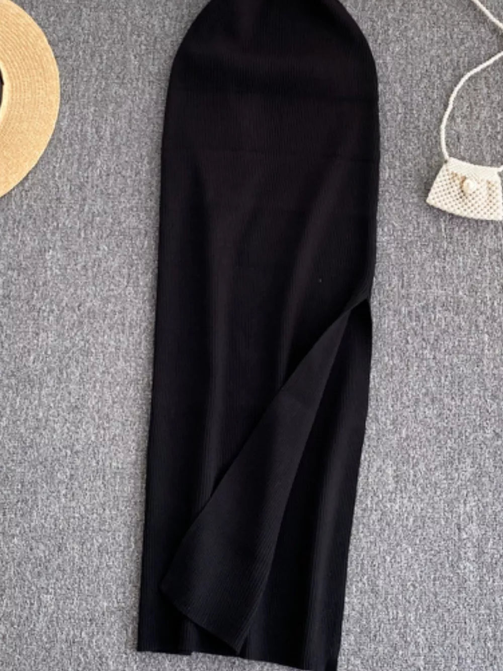 Black ribbed knit midi dress with a high slit and cutout detail.